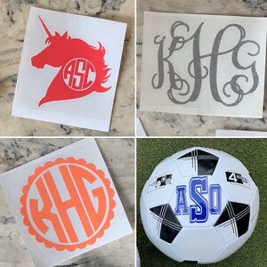 May include: Four different vinyl decals with monogram initials. The first decal features a pink unicorn with the initials "ASO" in a circle. The second decal features the initials "KHG" in a silver glitter font. The third decal features the initials "KHG" in a coral color with a scalloped border. The fourth decal features a soccer ball with the initials "ASO" in blue.