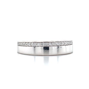 May include: A silver ring with a band of small, clear gemstones set along the top edge. The ring has a polished, reflective surface and a simple, elegant design. The ring is set against a white background.