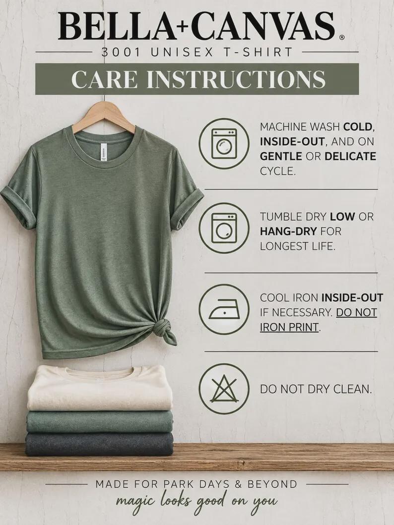 May include: A sage green t-shirt hanging on a wooden hanger with a knot at the hem, stacked with three folded t-shirts in cream, green, and charcoal. The image displays Bella+Canvas 3001 care instructions including machine wash cold, tumble dry low, and cool iron.