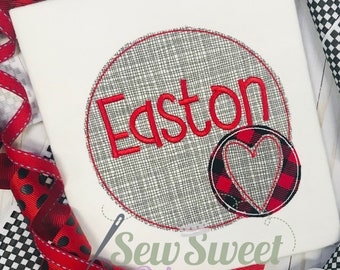 Peut inclure: T-shirt blanc avec un grand cercle brodé portant le nom "Easton" en rouge. Un petit cercle avec un motif de cœur est à droite. Des rubans rouges et noirs à pois et à carreaux entourent le t-shirt.