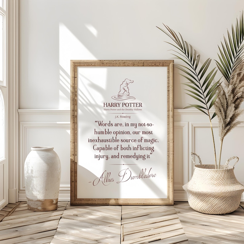 May include: A framed print with a quote from Harry Potter and the Deathly Hallows. The text, in a dark red font, is attributed to Albus Dumbledore. The frame is light brown, and the background is white. The image includes a Sorting Hat illustration.