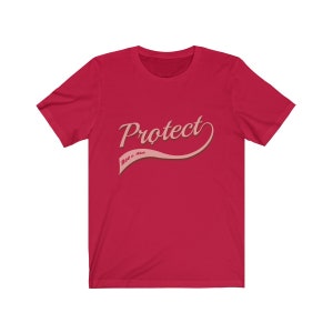 May include: Red t-shirt with a pink graphic that says "Protect Roe v. Wade" in a retro-style font.