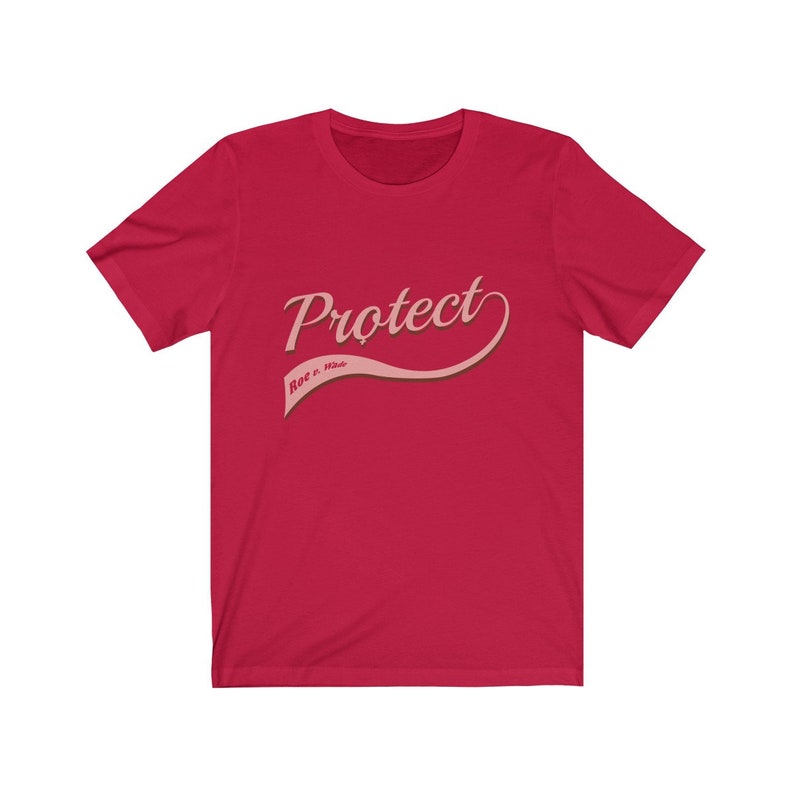 May include: Red t-shirt with a pink graphic that says "Protect Roe v. Wade" in a retro-style font.