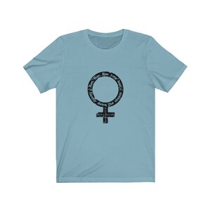 May include: Light blue t-shirt with a black and white graphic of a female symbol with the text "Row, Row, Row your boat, Gently down the stream".