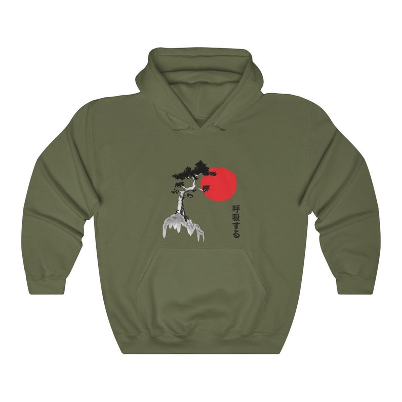 May include: A green hooded sweatshirt with a black and white image of a tree and a red sun. The Japanese text "呼吸する" is printed on the right side of the image.