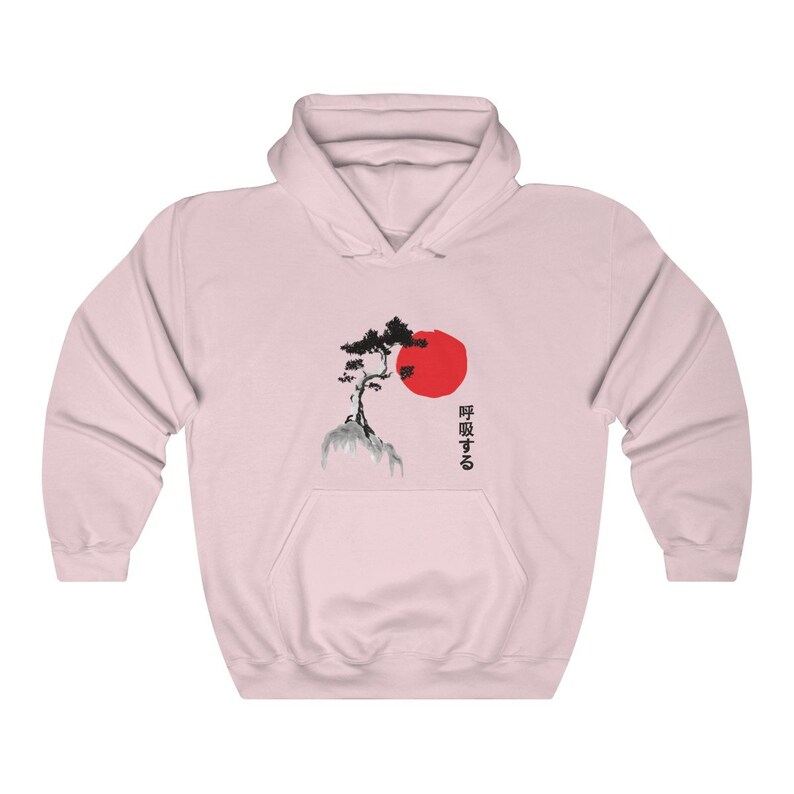 May include: Pink hooded sweatshirt with a black and white illustration of a tree on a rock with a red sun behind it. The Japanese text "呼吸する" is printed on the right side of the image.
