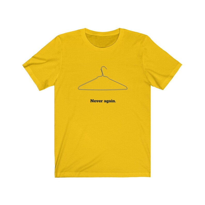 May include: A yellow t-shirt with a black outline of a wire hanger and the text "Never again."