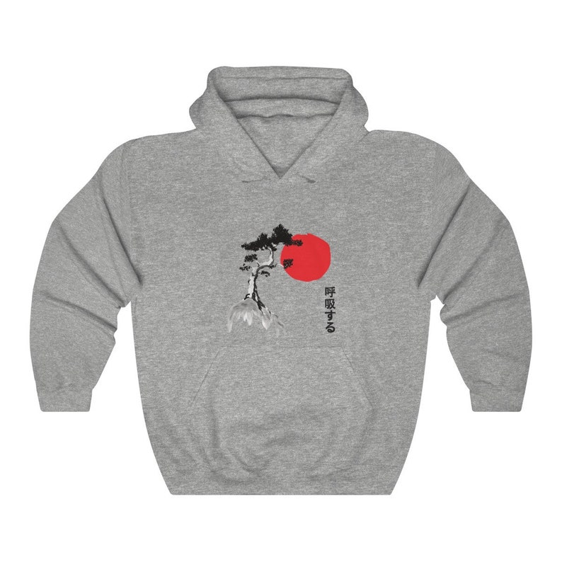 May include: A gray hooded sweatshirt with a black and white image of a pine tree and a red sun. The Japanese text "呼吸する" is printed on the right side of the image.