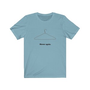 May include: A light blue t-shirt with a wire hanger graphic and the text "Never again."