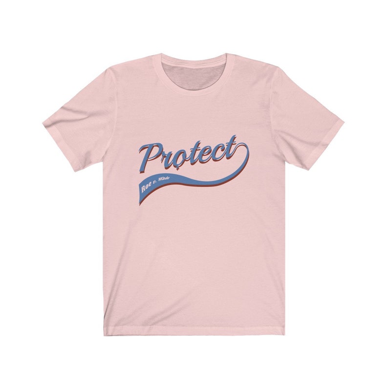 May include: Pink t-shirt with a blue and red "Protect Roe v. Wade" graphic.