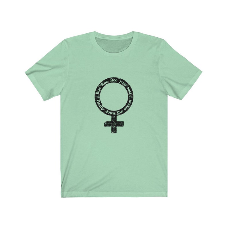 May include: A light green t-shirt with a black graphic of a female symbol. The graphic has the text "Row, Row, Row your boat gently down the stream" around the symbol.
