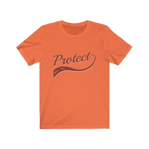 May include: Orange short-sleeved t-shirt with the text "Protect Roe v. Wade" in a brown retro-style font.