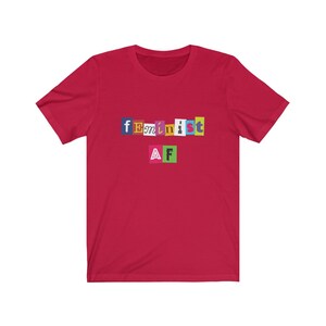 May include: Red short-sleeved t-shirt with the text "feminist AF" in colorful, cut-out letters.