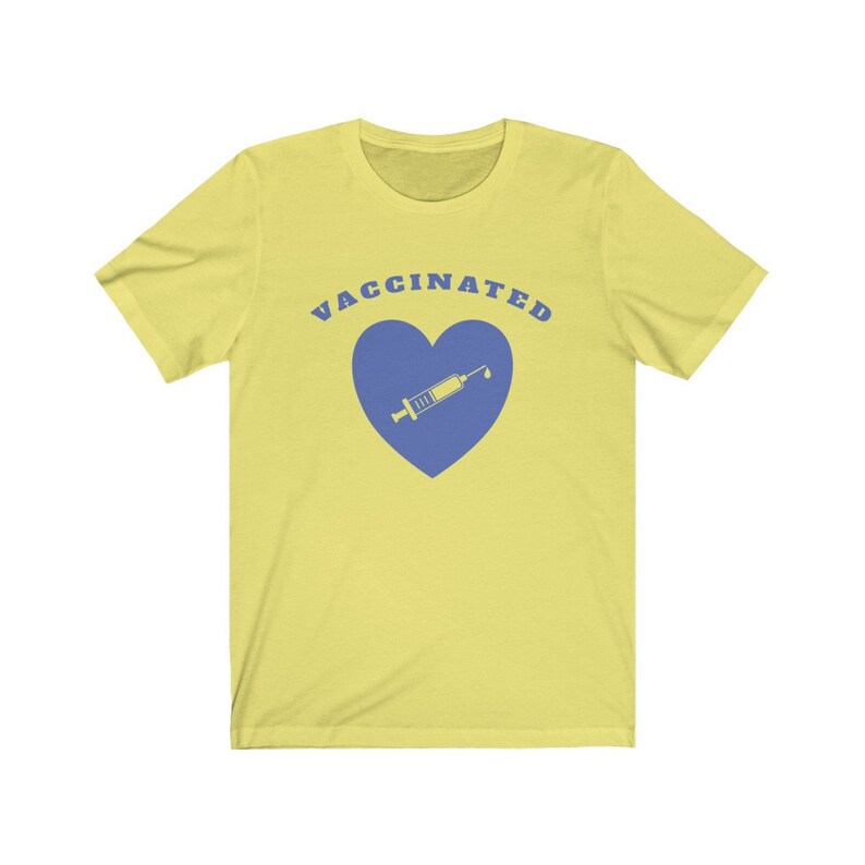 May include: Yellow short-sleeved t-shirt with the text "VACCINATED" in blue letters and a blue heart with a syringe inside.