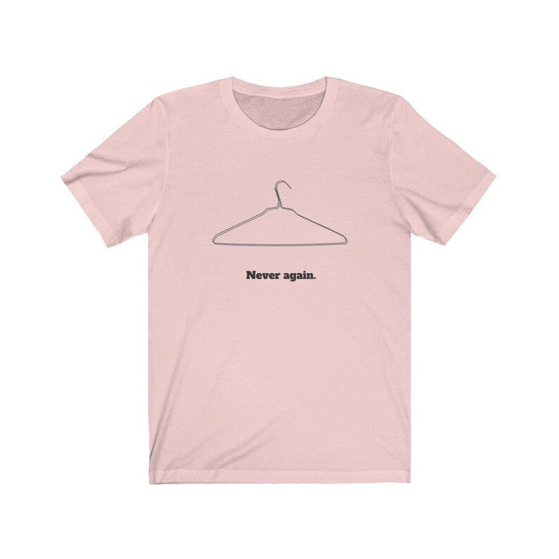 May include: A pink t-shirt with a black wire hanger and the text "Never again."