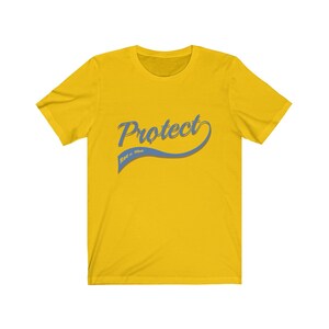 May include: Yellow short-sleeved t-shirt with a blue and white graphic that says "Protect Race & Hate".