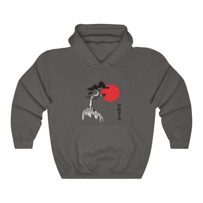 May include: A dark gray hoodie with a black and white illustration of a tree on a cliff with a red sun behind it. The Japanese text "時を取る" is printed on the right side of the image.
