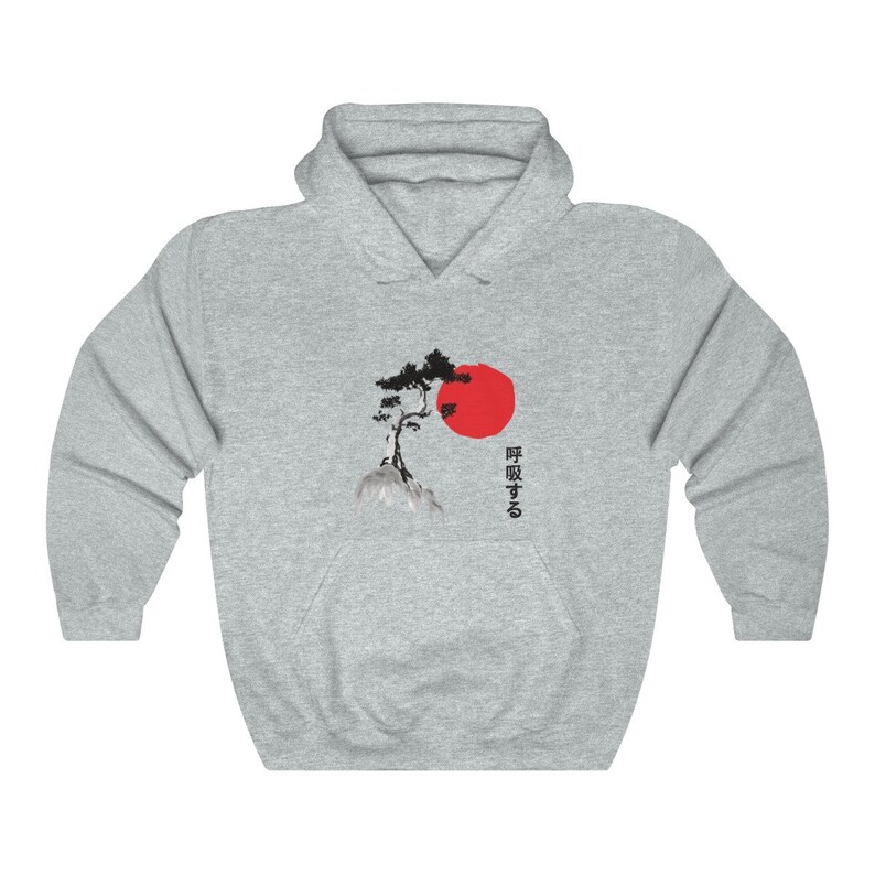 May include: A gray hooded sweatshirt with a black and white image of a pine tree on a rock with a red sun behind it. The Japanese text "呼吸する" is printed on the right side of the image.