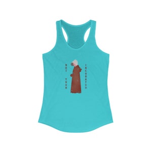 May include: A turquoise tank top with a white racerback design. The front of the tank top features a silhouette of a woman wearing a red robe and a white bonnet. The text "NOT YOUR INCUBATOR" is printed vertically on either side of the woman.