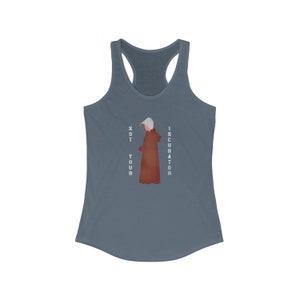 May include: A blue tank top with a white graphic of a woman in a red robe and the text "NOT YOUR INCUBATOR".