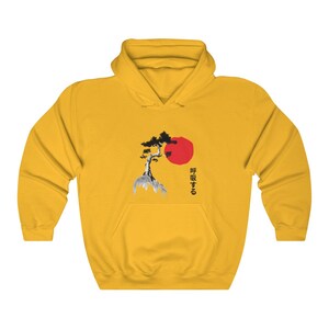 May include: Yellow hoodie with a black and white image of a tree and a red sun. The text "呼吸する" is printed in black below the image.