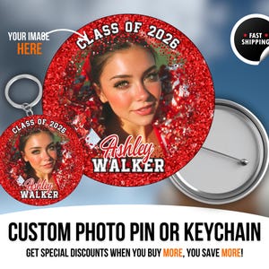 May include: A custom photo pin and keychain featuring a young woman's image, the text "Class of 2026," and the name "Ashley Walker." The pin and keychain have a red glitter background. The image also includes a fast shipping sticker.