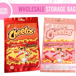 May include: Two red and pink resealable bags with a Cheetos logo and the text "Flamin' Hot Lushus". The bags are labeled with "NET WT 1.22 OZ (22.26)".