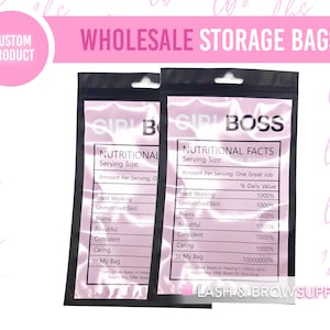 May include: Two black resealable plastic bags with pink and white text that reads "Girl Boss" and "Nutritional Facts". The bags are for storing small items and have a hang hole at the top.