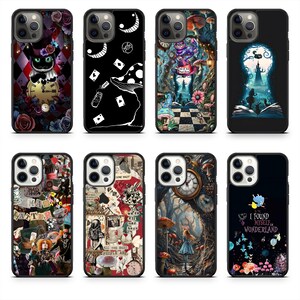 May include: A collection of phone cases featuring designs inspired by Alice in Wonderland. Designs include the Cheshire Cat, playing cards, mushrooms, and keyhole scenes. Cases are black with colorful illustrations.