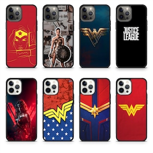 May include: Collection of phone cases featuring superhero designs. Includes cases with the Wonder Woman logo, a Justice League case, and cases with images of Wonder Woman. The cases are in various colors, including red, blue, and black.