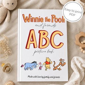 May include: A white book titled Winnie the Pooh and friends ABC picture book with red and yellow lettering. The cover features illustrations of Eeyore, Piglet, Winnie the Pooh, and Tigger, with the text Made with love by family and friends.