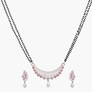 May include: A black beaded necklace with a pendant featuring a crescent-shaped design with pink and white stones. Matching earrings with a similar design are also included.