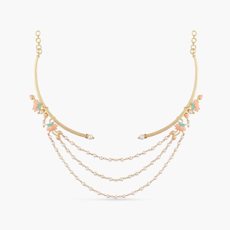 May include: A gold necklace with a delicate, curved design and a cascading row of pearls. The necklace features small, pink and turquoise enamel flowers.