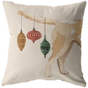 May include: A watercolor illustration of a dog's rear end with three Christmas ornaments hanging from its tail. The ornaments are red, green, and gold.