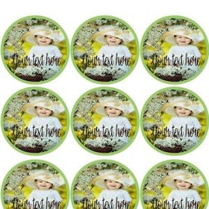 May include: Twelve round green and white cupcake toppers featuring a photograph of a baby girl wearing a white hat and a white dress. The text "Your text here" is printed on each topper.