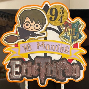 May include: A Harry Potter themed cake topper with a cartoon character holding a broom, a Hogwarts house crest, and the text "9 3/4" and "10 Months Eric Trifan".