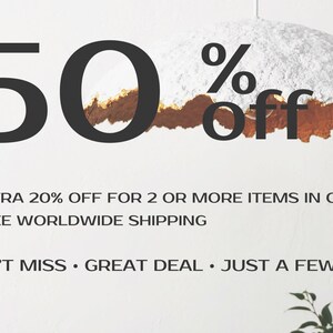 May include: A white and gold textured paper lampshade with a 50% off sale announcement. The text also says "Extra 20% off for 2 or more items in cart" and "Free worldwide shipping". The text also says "Don't miss. Great deal. Just a few days."