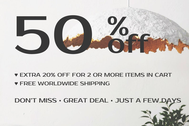 May include: A white and gold textured paper lampshade with a 50% off sale announcement. The text also says "Extra 20% off for 2 or more items in cart" and "Free worldwide shipping". The text also says "Don't miss. Great deal. Just a few days."