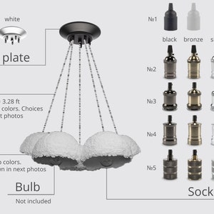 May include: A three-light pendant lamp with white fabric shades. The lamp has a black ceiling plate and a cord that is 3.28 feet long. The lamp comes with a choice of five different socket colors: black, bronze, silver, and copper. The bulb is not included.