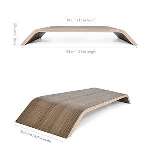 May include: Wooden laptop stand with a curved design. The stand is 21 inches long, 15 inches wide, and 3 inches high.