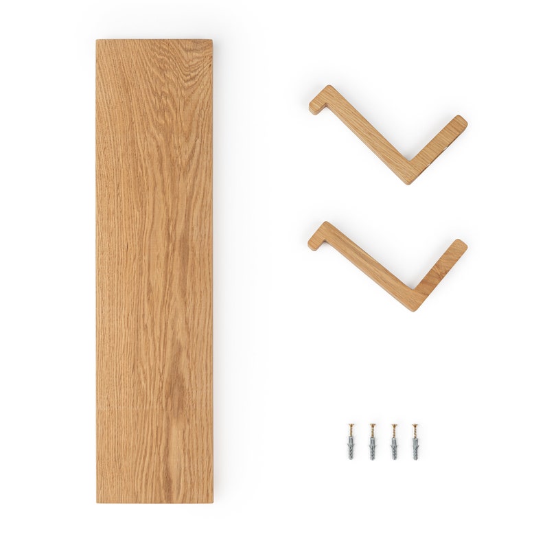 May include: A set of two wooden wall shelves with a natural wood finish. The shelves are shaped like a chevron and come with mounting hardware.