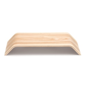 May include: A natural wood laptop stand with a curved design. The stand is made of light wood with a natural grain pattern.