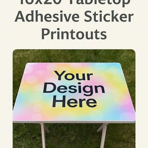 May include: A small, white tabletop with a colorful, pastel design. The tabletop measures 16x20 inches and features the text "Your Design Here" in black. The table is set on a grassy surface.
