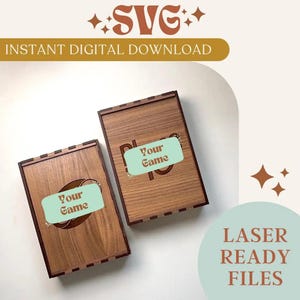 May include: Two wooden game boxes with engraved designs and the words "Your Game" on a light green label. The boxes are made of light brown wood. The image also includes the text "SVG INSTANT DIGITAL DOWNLOAD" and "LASER READY FILES".
