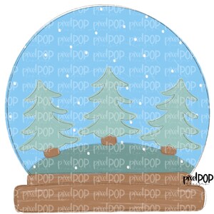 May include: A blue glass snow globe with a white background and three green pine trees inside. The snow globe has a brown wooden base with the text "PixelPOP Designs" on it.