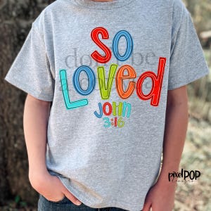 May include: A gray t-shirt with the words "so loved" in rainbow colors and the text "John 3:16" underneath.