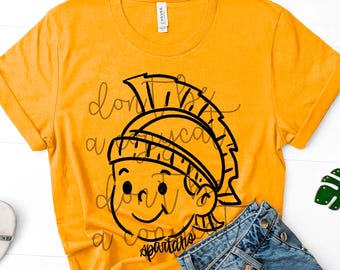 May include: Mustard yellow t-shirt featuring a black cartoon Spartan graphic. The graphic includes a helmet and the word "Spartans". The shirt is paired with blue denim shorts. The text "Don't be a" is also visible.