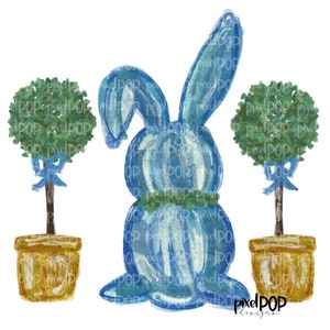 May include: A blue watercolor bunny with a green wreath around its neck, standing between two topiary trees in gold pots with blue ribbons. The trees are green and round.