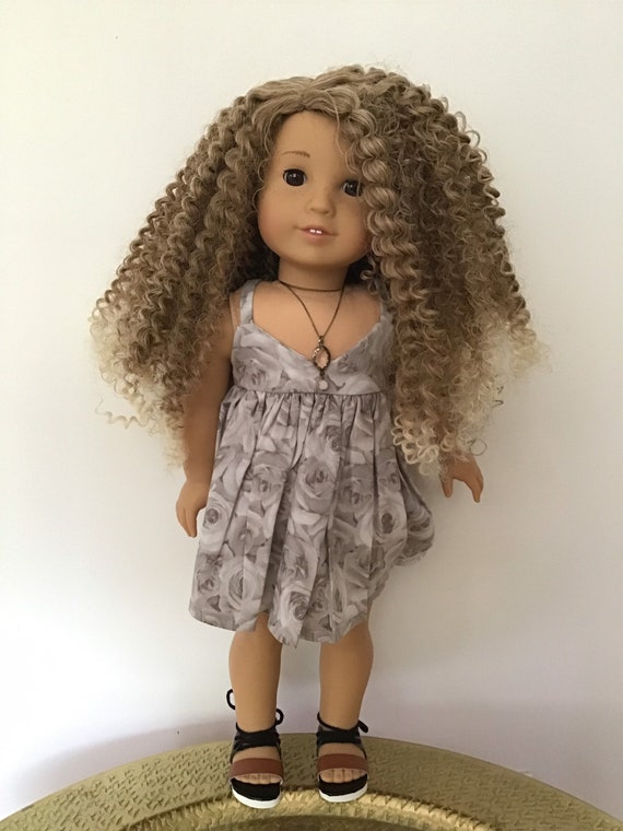 doll with brown curly hair and brown eyes
