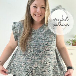 May include: A woman wearing a crocheted top with a green, white, and pink color pattern. The top has a v-neck and short sleeves. The text "crochet pattern" is written in a circle on the image.